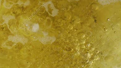 Abstract close-up on the surface of boiling water and oil