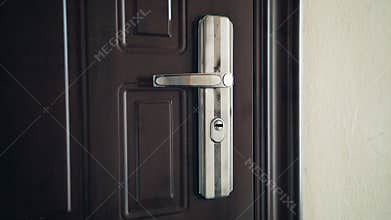 Close up on a door handle as the door is opened. Symbol of new hope, fresh starts and making an entrance.