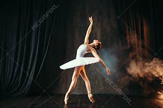 Ballerina in white dress dancing in ballet class