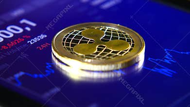 Gold coins of the ripple on the background of a graphic stock chart. The Concentration of the Crypto-Currency of Virtual