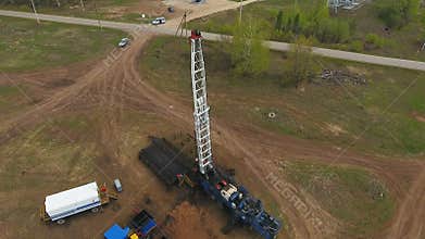 Factory Workers Settle Oil Well Mechanism in Field