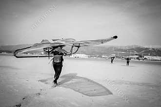Windsurfer Carrying Board in Tarifa, Andalucia, Spain