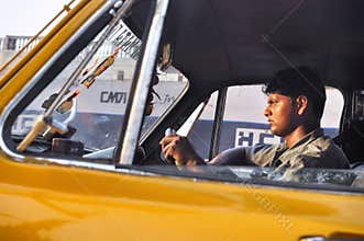 KOLKATA INDIA - APRIL 2012 : Taxi driver man driving car in Kolkata, India as of April 16, 2012