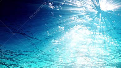 Looping animation of ocean waves from underwater with floating plankton. Light rays shining through. Great popular