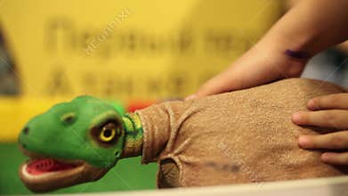People are stroking a dinosaur robot. Modern robotic technologies. Artificial intelligence. Cybernetic systems today.