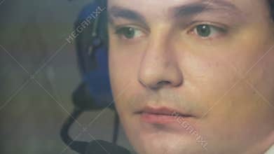 Tired pilot in headset navigating commercial plane, responsibility, commitment