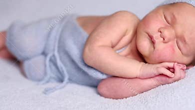 Newborn baby lying on soft plaid