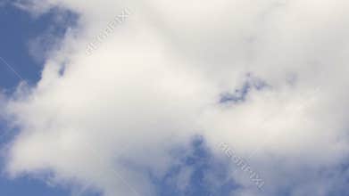 Academic cap with tassel thrown up in air flying against blue sky background