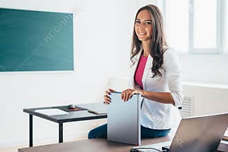 Portrait of female school teacher smiling at camera