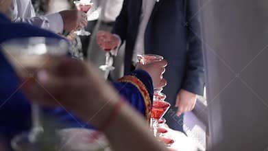 People taking glasses of sparkling wine at the party