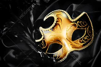 Carnival mask on black silk background