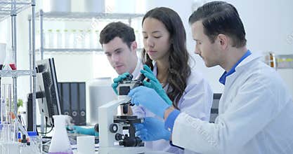Dolly Shot of Medical Research Scientists Team Work on Modern Laboratory with Scientists Conducting experiments, Working