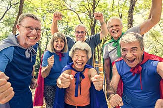 Childlike seniors wearing superhero costumes