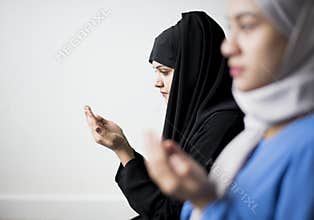 Muslim women making Dua to Allah