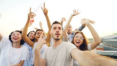 Point of view shot of bearded guy popular blogger recording video for internet vlog at modern open-air party with