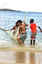 Little fishermen team with net trying caught fish