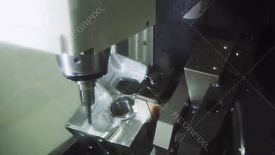 The CNC milling machine cutting the aluminium automotive part with the solid. Modern manufacturing process