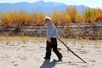 Boy walking along river