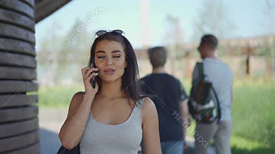 Young woman walking and calling by the phone