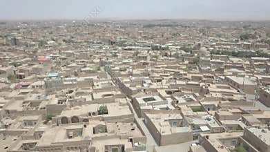 Aerial drone view of the houses next to the Azadi tower in Tehran. Waving flag.