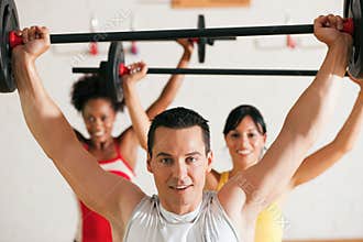 Fitness group with barbell in gym