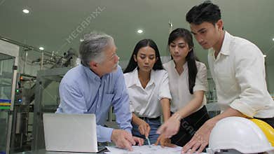 Senior Manager and industrial engineers team checking on production plans in a factory.