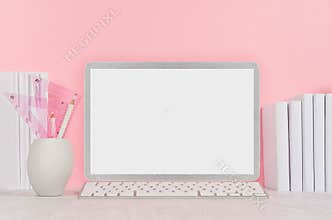 Back to school background for girl`s - white stationery, blank laptop computer and books on soft pink wall and white wood desk.