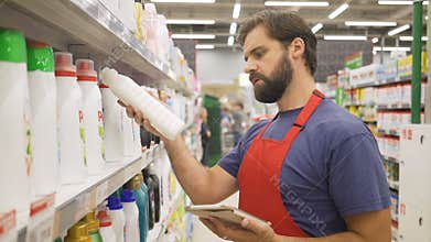 Sales clerk with digital tablet doing a stocktake in household store