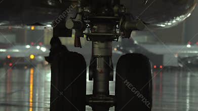 Airplane wheel, view at rainy evening