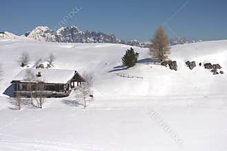 a house covered by snow in the high mountains