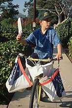 Newspaper boy on delivery papers