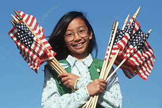 Filipino Girl Scout holding American flags