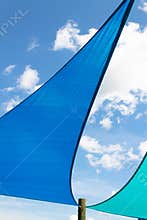 Triangle shades against a bright blue sky