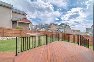 House deck with wooden flooring and metal railings