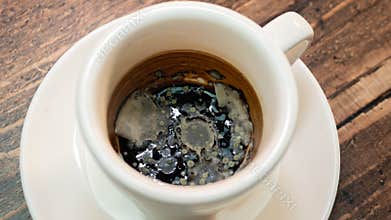 Black moldy coffee, fungus blooming coffee drink in a cup.