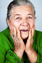 Happy and amazed old senior woman