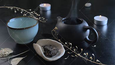 Pour boiling water into the teapot. Chinese tea ceremony. Ceramic kettle. Close-up.
