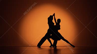 Couple of dancers approach each other and begin to dance Argentine tango. Elements of latin ballroom dance in studio