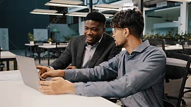 Arabian man financial analyst explain business strategy African entrepreneur pointing on laptop discussing startup