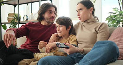 Family watching movie on tv at home