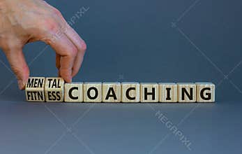 Mental or fitness coaching symbol. Coach turns cubes and changes words Fitness coaching to Mental coaching. Beautiful grey