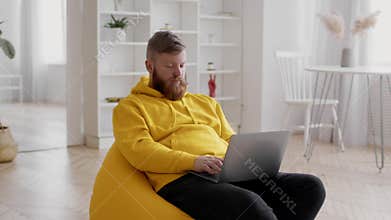 Freelancer Man Using Laptop Working Online Sitting At Home