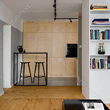 Kitchen behind white bookcase