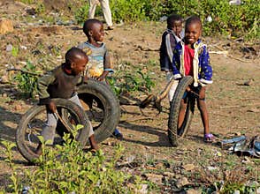 African little children playing with old moto wheels