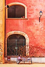 After playing in the street, two children have a moment of rest and time to eat.