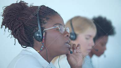 Serious African American call center worker in headset
