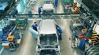 Top view of people working on car assembly line.