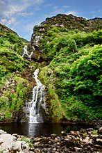 Beautiful water cascade of Powerscourt Waterfall, the highest waterfall in Ireland. Famous tourist atractions in co