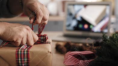 Close up static video of packing Christmas present.