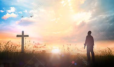 Man Silhouette Looking At Cross During Sunrise Spiritual Faith Concept